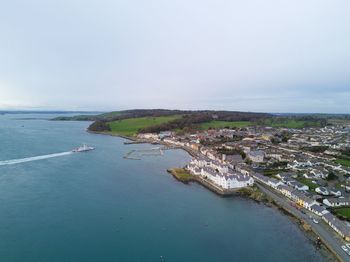 Scenic view of sea by city against sky