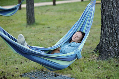 Woman laying and relaxing in hammoc