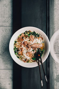 Directly above shot of meal served on table, pho soup, in restaurant, asian food.