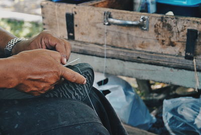 Close-up of person holding shoe