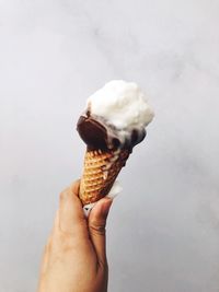 Cropped image of hand holding ice cream