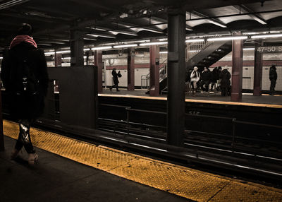 People waiting at railroad station platform