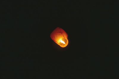 Low angle view of illuminated lamp against clear sky at night