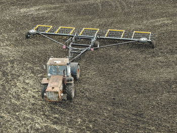 High angle view of tractor and agricultural equipment on field