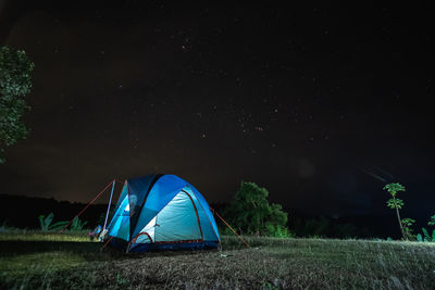 Scenic view of tent on field against sky at night