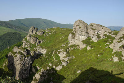 Scenic view of rocky mountains against clear sky