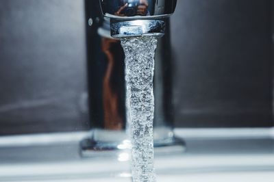 Close-up of water flowing from faucet