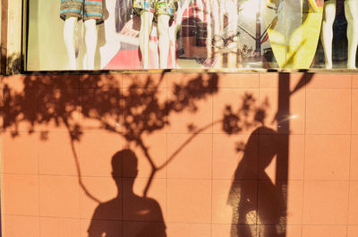 Shadow of people walking on tiled floor