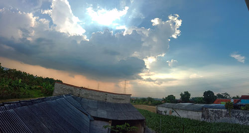 Panoramic view of building against sky during sunset
