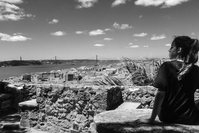 Side view of woman looking at cityscape in lisbon, portugal. 