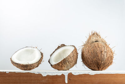 Close-up of bread on table against white background