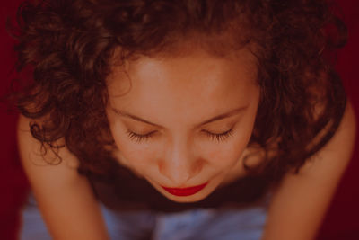 High angle view of young woman with eyes closed sitting at home