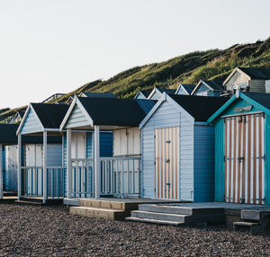 Colorful beach huts during sunset by the sea, holiday and travel concept.