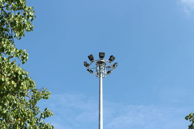 Low angle view of street light against blue sky