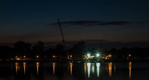 Reflection of buildings in river at night