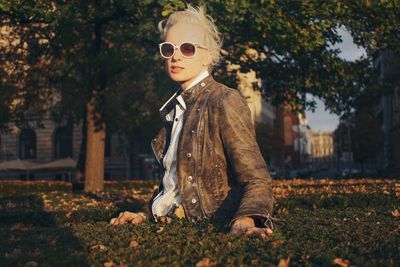 Boy wearing sunglasses on field during autumn