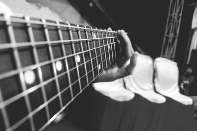 Cropped hand of man playing guitar
