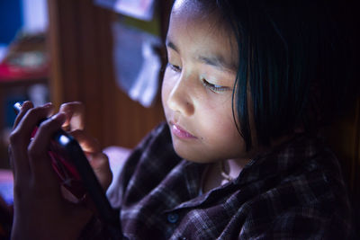 Close-up of girl using mobile phone