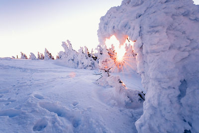 Scenic view of snow covered landscape against sky