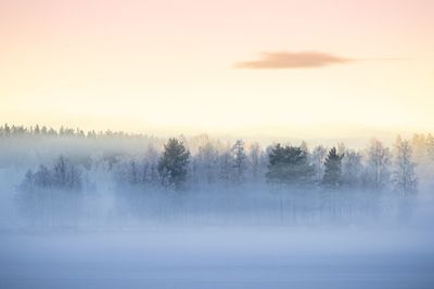 Scenic view of lake against sky at sunset