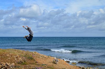 Man jumping against the background of the sea