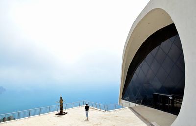 Person on sea against sky