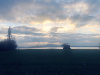 Scenic view of field against sky during sunset