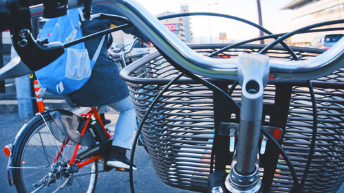 Close-up of bicycle parked by railing in city