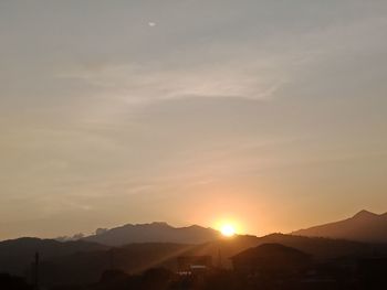 Scenic view of silhouette mountains against sky during sunset