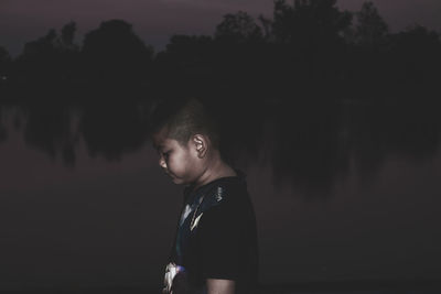 Portrait of boy looking at lake