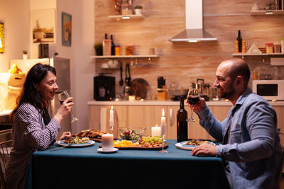 Portrait of young woman drinking wine in restaurant