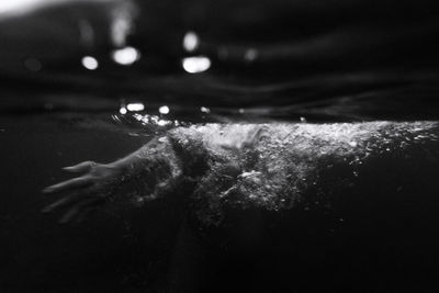 Girl hand underwater photo with slow shutter