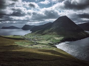 Scenic view of sea and mountains against sky