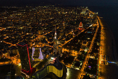 High angle view of city lit up at night