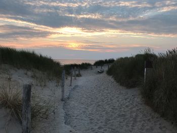 Scenic view of beach against sky during sunset