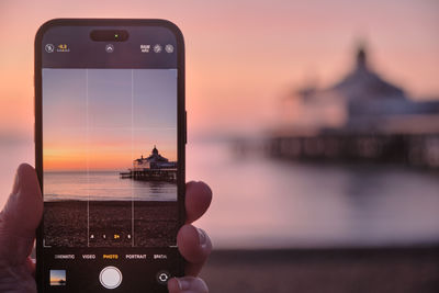 Cropped hand using mobile phone