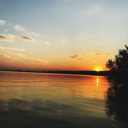 Scenic view of sea against romantic sky at sunset