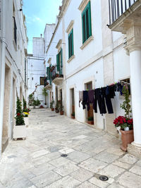 Drying clothes on the street amidst buildings in city