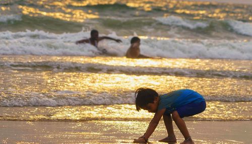 Rear view of people on beach