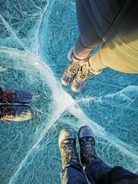 Low section of people standing on frozen lake