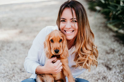 Portrait of a smiling young woman with dog