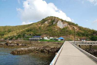 Scenic view of lake by mountain against sky