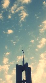 Low angle view of building against cloudy sky