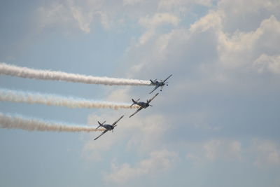 Low angle view of airshow against sky