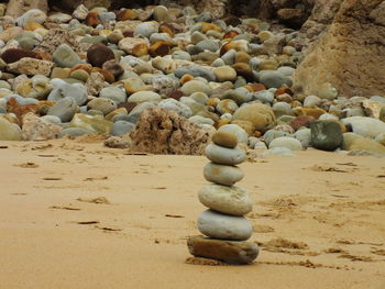 Stack of pebbles on sand at beach