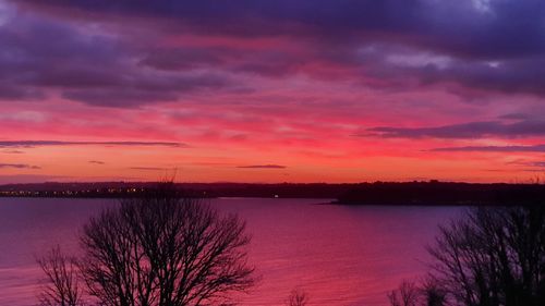 Scenic view of lake against romantic sky at sunset