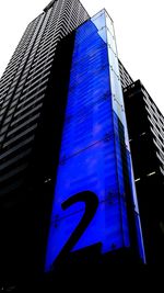 Low angle view of modern building against blue sky