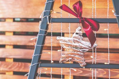 Close-up of tied hanging on metal