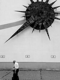 Rear view of man walking on wall