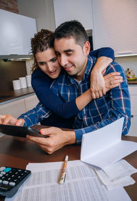 Young man using smart phone on table